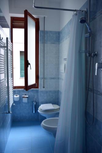 a bathroom with a shower and a toilet and a sink at Hotel Corallo in Moneglia