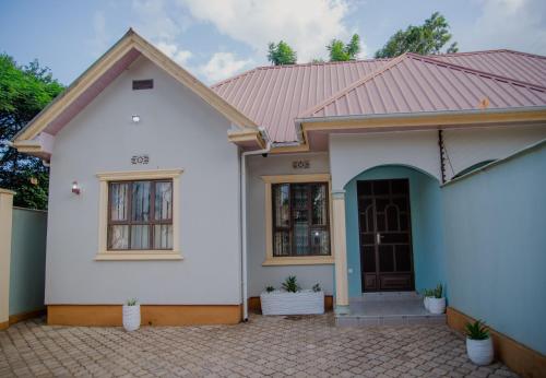a white house with a red roof at Sisi's Homes in Arusha