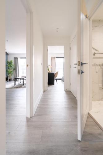 an open hallway with white walls and wood floors at Oasis at Hemel Hempstead in Hemel Hempstead