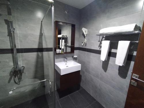 a bathroom with a sink and a shower at Karam Al Diyafa Hotel in Jeddah