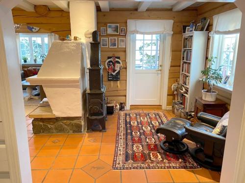 a living room with a wood stove in a room at Tømmerhus nær Tusenfryd utenfor Oslo. in Ås