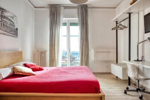 a bedroom with a red bed and a window at SAPIENZA Apartment in Rome