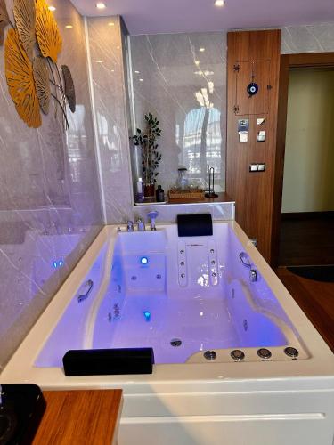 a jacuzzi tub in a bathroom with at SABİHA GOKCEN İSTANBUL HOUSES Airport in Istanbul