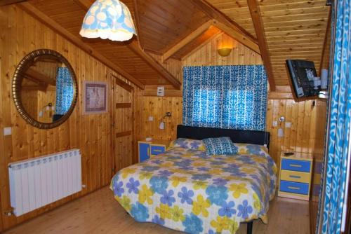 a bedroom with a bed in a wooden cabin at 5 bedrooms chalet with shared pool jacuzzi and terrace at Alcaniz in Alcañiz