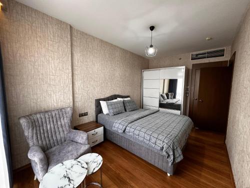 a bedroom with a bed and a chair at SABİHA GOKCEN İSTANBUL HOUSES Airport in Istanbul