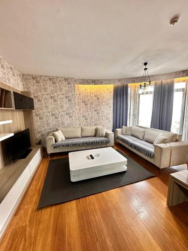 a living room with a couch and a table at SABİHA GOKCEN İSTANBUL HOUSES Airport in Istanbul