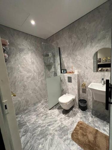 a bathroom with a toilet and a sink at Elite Apartment 3 in Riyadh