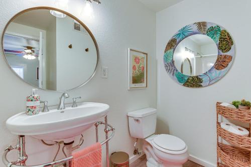 a bathroom with a sink and a mirror and a toilet at Lakefront Graford Home with Fire Pit and Private Dock! in Graford