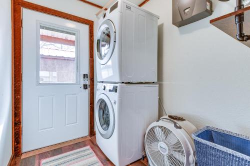 a laundry room with a washer and dryer next to a door at Lakefront Graford Home with Fire Pit and Private Dock! in Graford