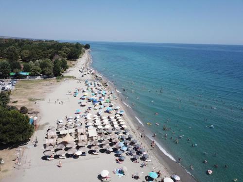 an overhead view of a beach with people and umbrellas at OLYMPUS Paradise 1 in Skotína