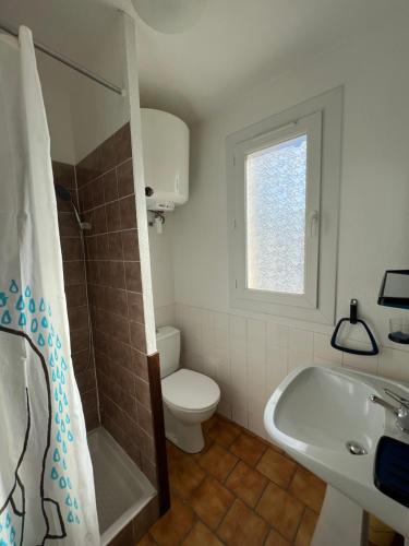 a bathroom with a toilet and a tub and a sink at Bourgarel in Vidauban