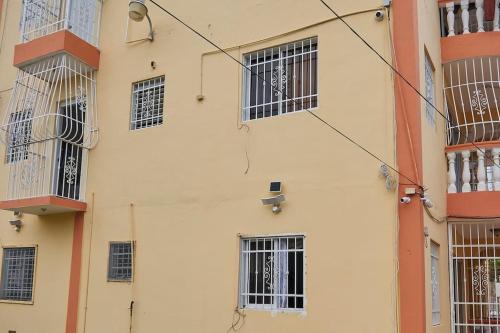 a building with barred windows on the side of it at Bright Charming Apartment in San Pedro de Macorís