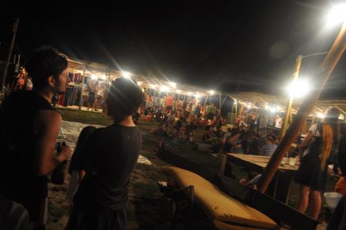 a group of people standing in front of a crowd at night at Complejo Sol de Valizas in Barra de Valizas