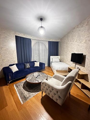 a living room with a couch and a table at SABİHA GOKCEN İSTANBUL HOUSES Airport in Istanbul