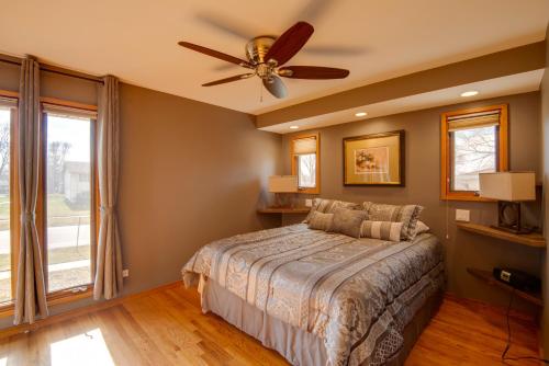 a bedroom with a bed and a ceiling fan at Charming Illinois Retreat with Hot Tub, Deck and Grill in Schaumburg