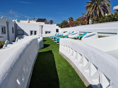 a row of chairs on the side of a white building at Gaviotas Golf Beach in Almerimar