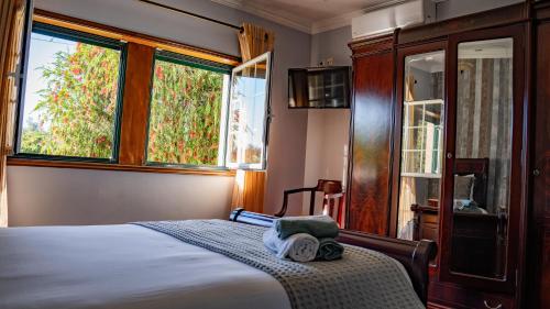 Ein Bett oder Betten in einem Zimmer der Unterkunft SERENIDADE ROOMS