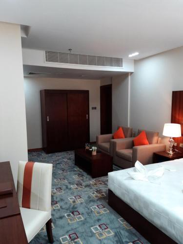 a hotel room with a bed and a couch at SBY Hotel فندق اس بي واي in Jeddah