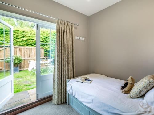 a bedroom with a bed with a teddy bear on it at 2 Bed in Easingwold 84000 in Crayke