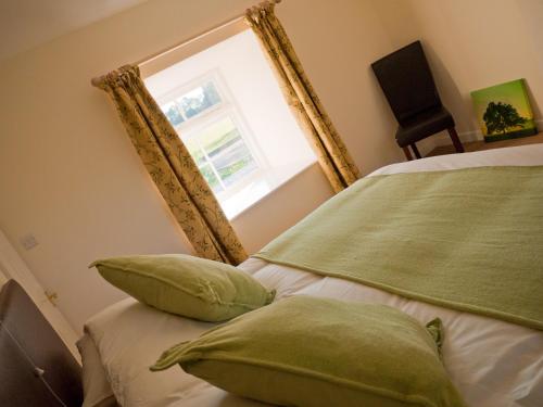 a bedroom with two beds and a window at 2 Bed in Ripon HH039 in Bishop Monkton
