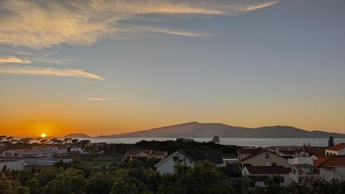 a view of a city at sunset at Loving Strangers Hostel in Madalena