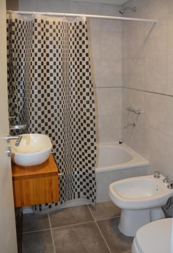 a bathroom with a sink and a toilet and a shower at Aparts VC in Villa Constitución