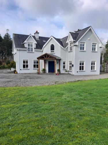 a large white house with a large yard at KYLEARD Ryan in Monasterevin