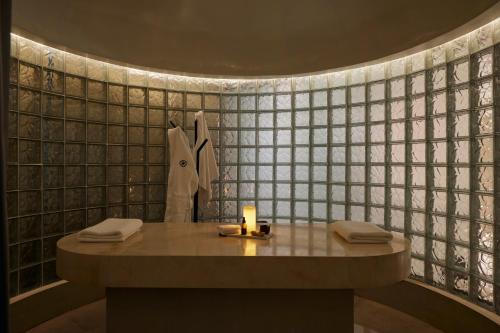 a bathroom with a table with a candle on it at Wellcomm Spa & Hotel in Medellín