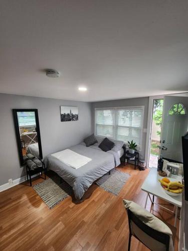 a bedroom with a bed and a table and chairs at Cozy studio in a lovely area in Forest Hills