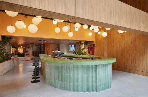 a lobby with a bar in a building at Wellcomm Spa & Hotel in Medellín