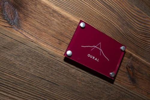 a red sign on a wooden table with a heartbeat at OURAL Annecy Rent Lodge in Annecy