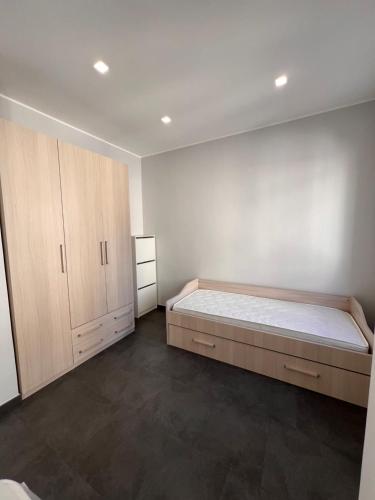 a bedroom with a large bed and wooden cabinets at La dimora di Serenella in Montescaglioso