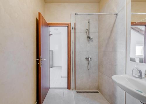 a bathroom with a shower and a sink at Apartments Podstrana with shared Pool in Podstrana