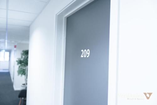 een deur in een kantoor met het nummer erop bij Vertikalen in Lillesand