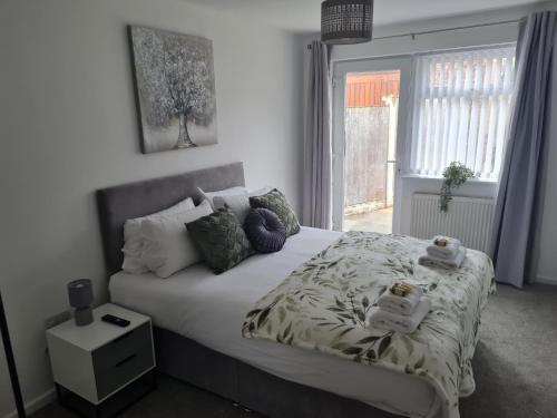 a bedroom with a bed with pillows and a window at 5Bed House Wirral near Liverpool Chester in Wirral