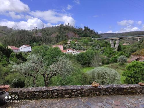 a view of a valley with a bridge and trees at Casa Nelito in Pedrógão Grande