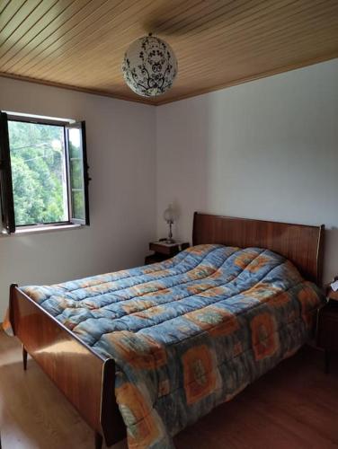 a bedroom with a large bed in a room at Casa Nelito in Pedrógão Grande