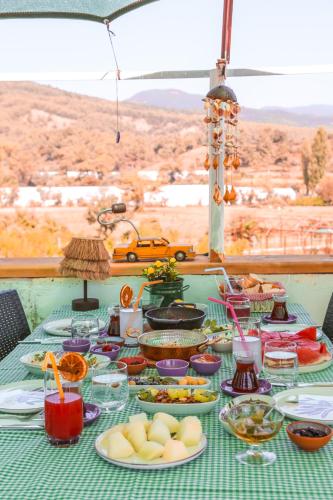 a table with plates of food on a table at Kandybos Eco Farm Village in Kas