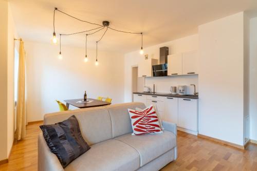 a living room with a couch and a kitchen at Weingut Köfelgut - Turris Vini in Castelbello-ciardes