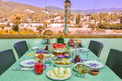 a table with plates of food and drinks on it at Kandybos Eco Farm Village in Kas
