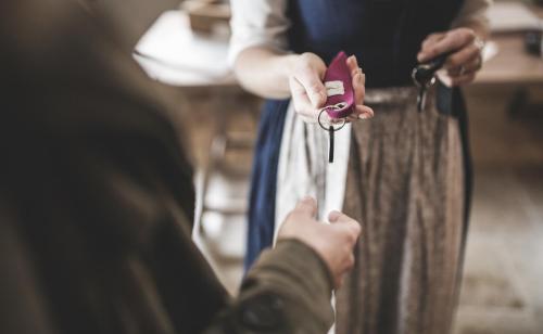 a person holding a bag with a pair of scissors at Lech Lodge - LEGENDARY in Lech am Arlberg