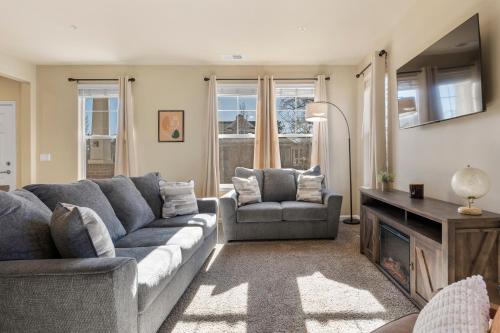 a living room with a couch and chairs and a television at MidTown Hideaway Fire Pit and King Beds in Reno