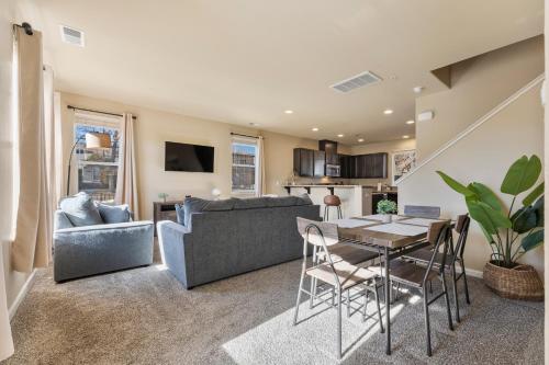 a living room with a table and a couch at MidTown Hideaway Fire Pit and King Beds in Reno