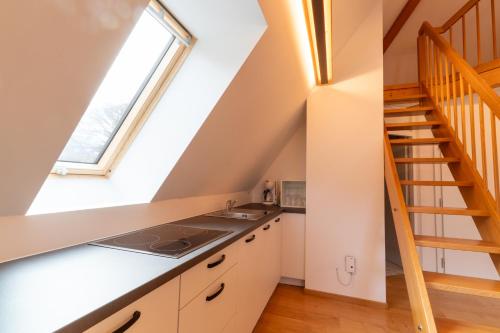 a kitchen with white cabinets and a window at Weingut Köfelgut - Turris Vini in Castelbello-ciardes