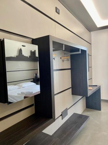 a bedroom with a bed and a large mirror at Palace Hotel Due Ponti in Siena
