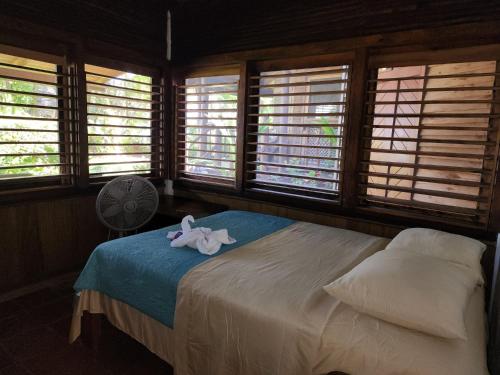 a bedroom with a bed with a pink flower on it at Nirvana Resort in Lívingston