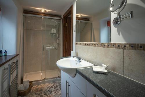 a bathroom with a sink and a shower at Wavering in Axbridge