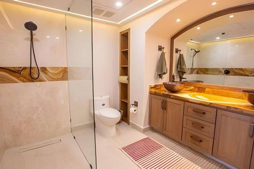 a bathroom with a shower and a toilet and a sink at Grand Marina Villas in Nuevo Vallarta