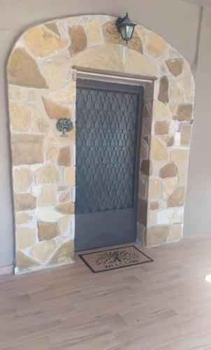 a stone wall with a door in a room at Βίλα Ελιά Παραδοσιάκο σπίτι στην Αμφίκλεια in Amfiklia