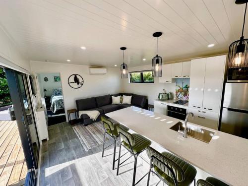 a kitchen and living room with a couch and a table at Heaven's Rest B&B in Pukekohe East
